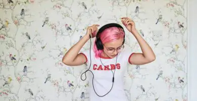 enthusiastic young woman with pink hair listening to music at home 769729481 5b91dd194cedfd0025d904d9 5c8014a746e0fb00011bf415