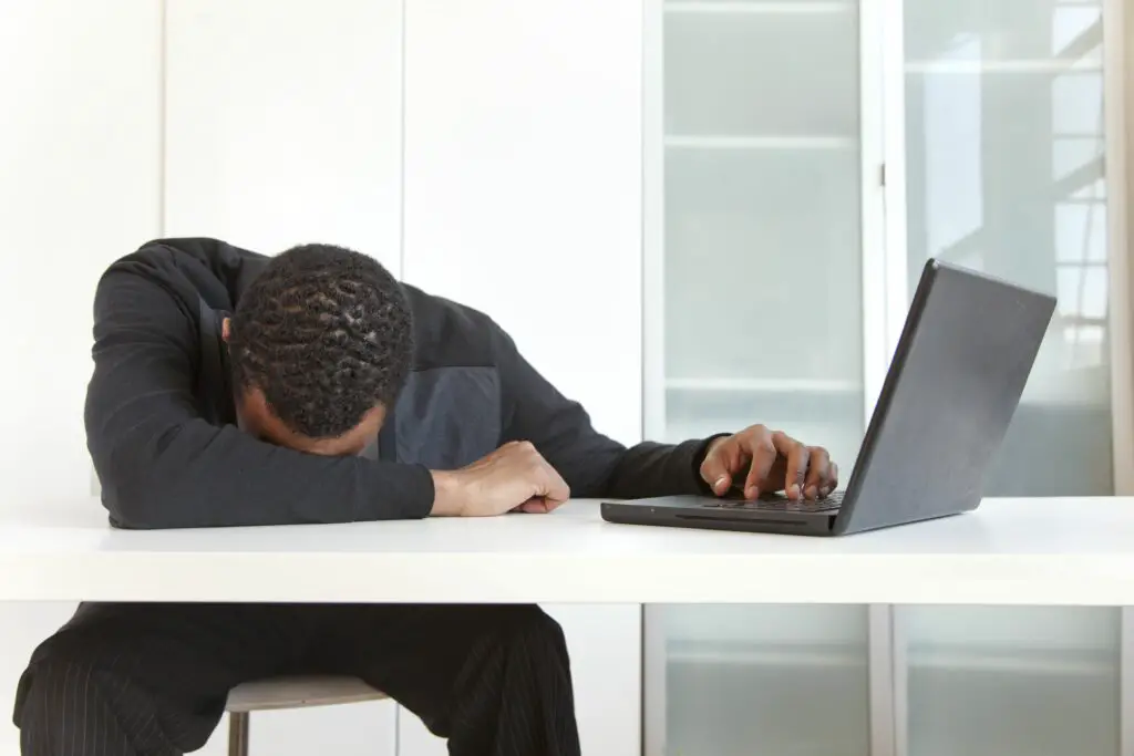 tired black businessman sleeping near laptop 145062352 5a318d219e94270037fa65b2