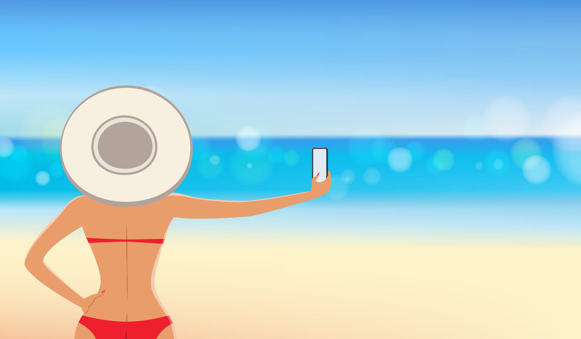 En kvinna som tar en selfie på stranden.