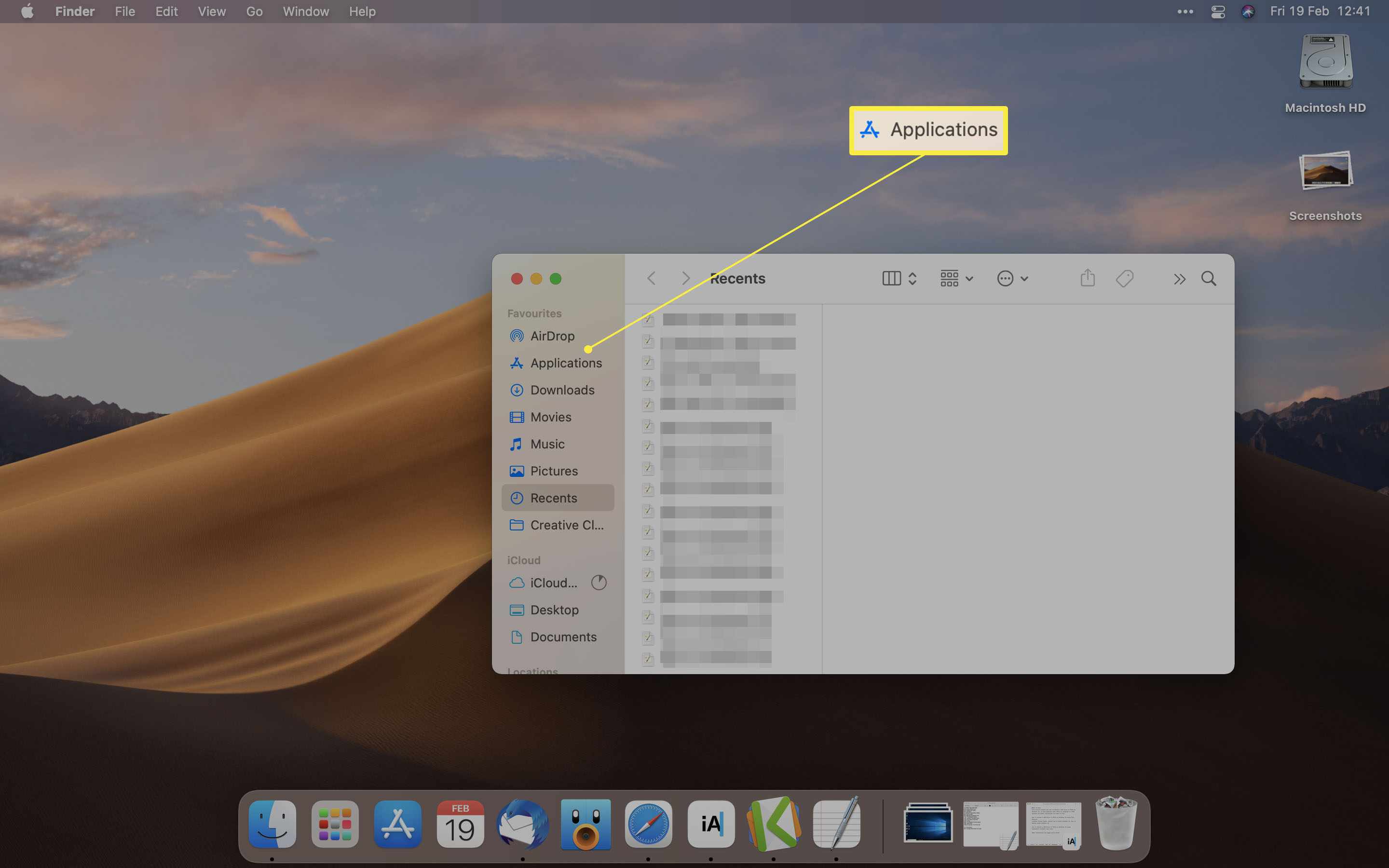 Mac-skrivbord med mappen Program markerat på Finder