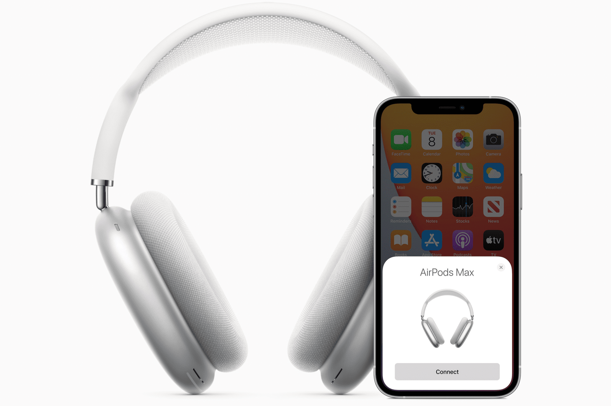AirPods Max i vitt bredvid en iPhone ihopkopplad med den