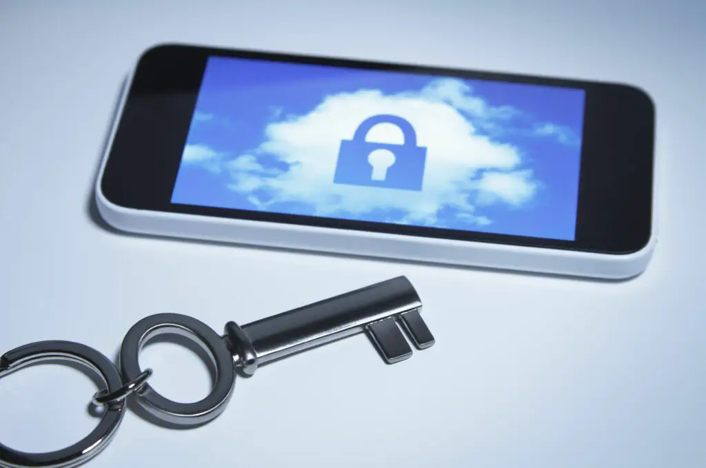 secure smart phone a key next to smartphone with a lock over a cloud on its screen 499133405 5b2718cd43a10300374a9680