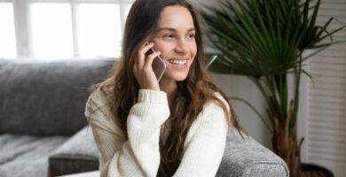 smiling millennial mestizo woman talking on the phone at home 934913078 5afd8c038023b9003692d3c1