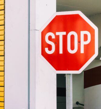 stop sign against building 752178835 5bf02fd4c9e77c0051d06485