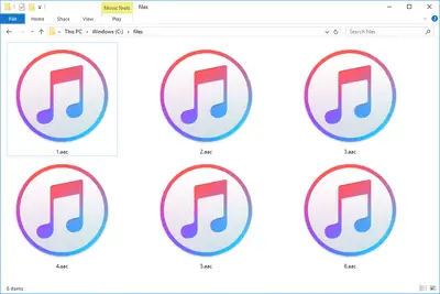 Skärmdump av flera AAC -filer i Windows 10 som öppnas med iTunes