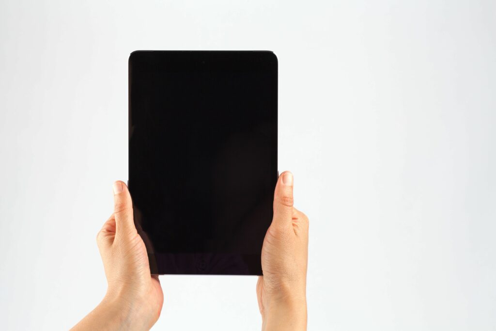 cropped hands of person holding digital tablet against white background 903957418 5b898708c9e77c007b5ecdce
