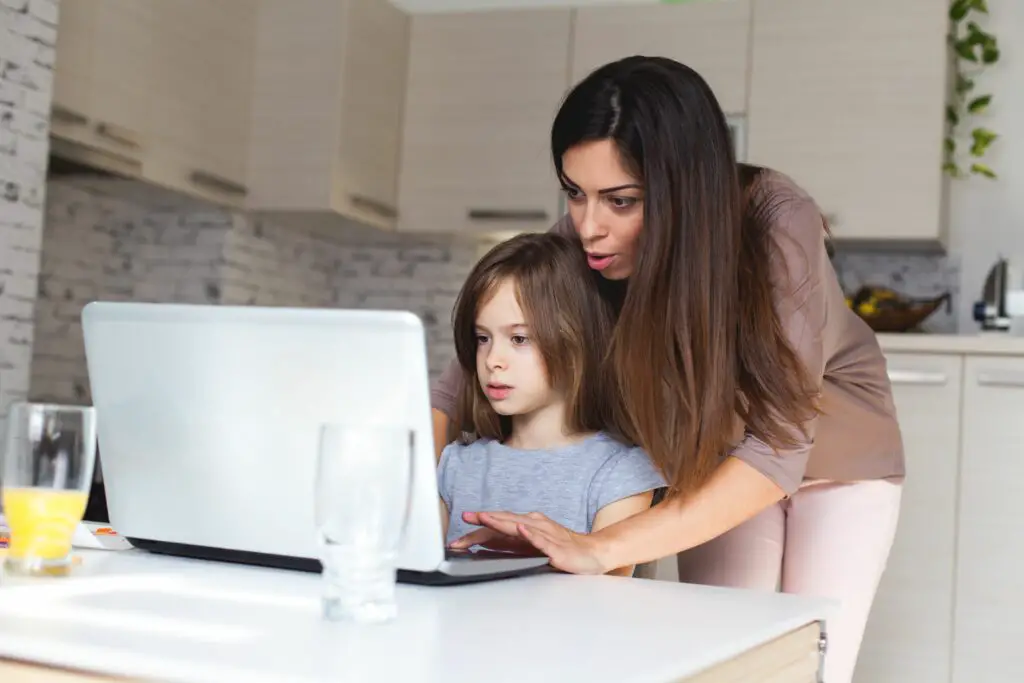 cute girl and mother using laptop at home 621830380 5b84905d4cedfd00258fa836