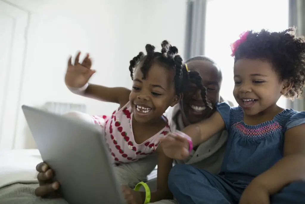 father and daughters waving video chatting using digital tablet 664657787 5b896d0fc9e77c002588cc13