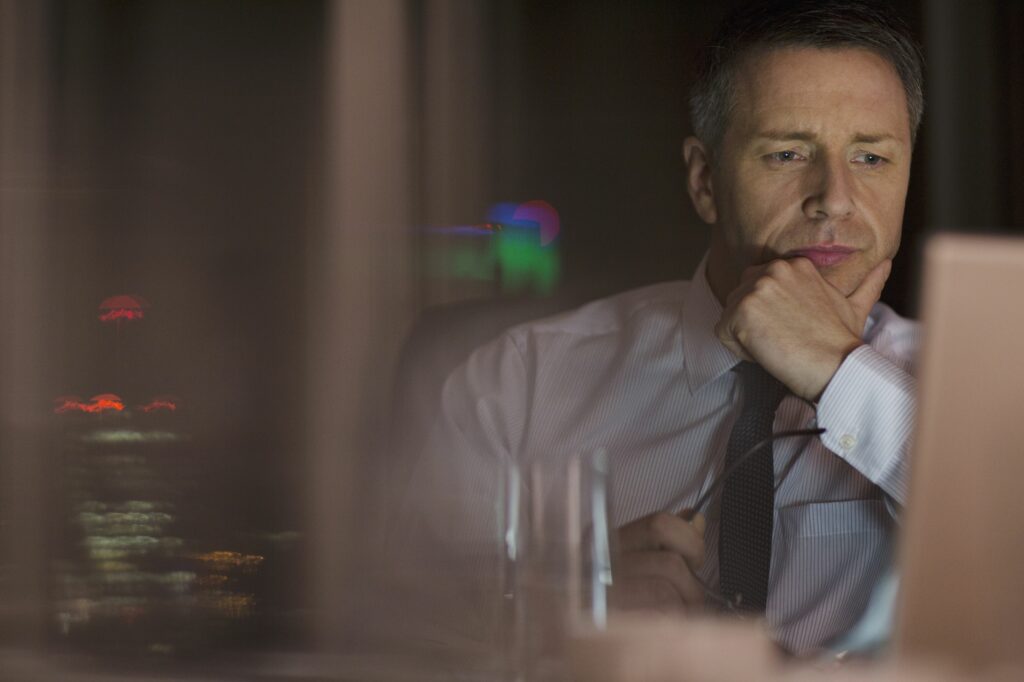 pensive businessman working late at laptop in office 500796897 5a84e2038e1b6e00367c08ca