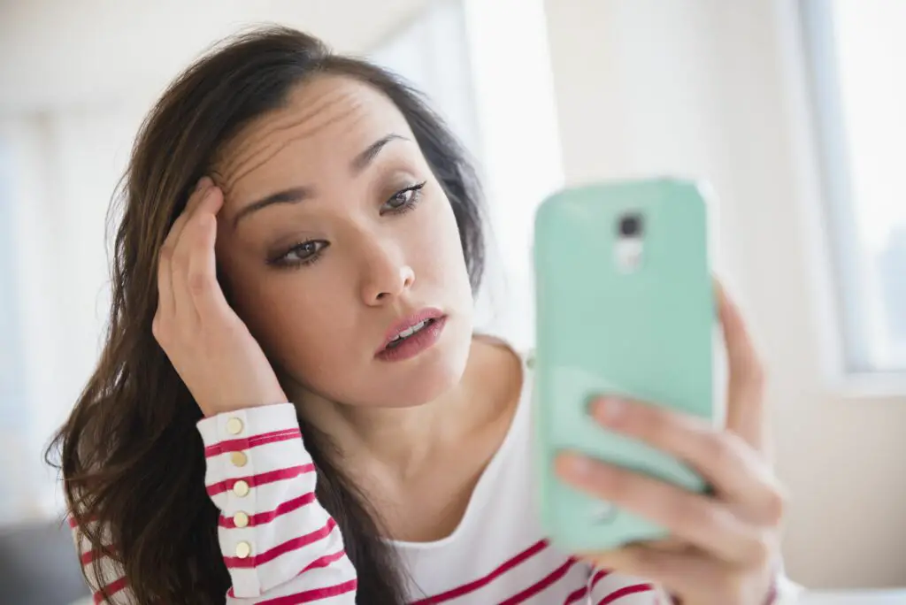 stressed woman using cell phone 649660615 5c5355e34cedfd0001efd4cb