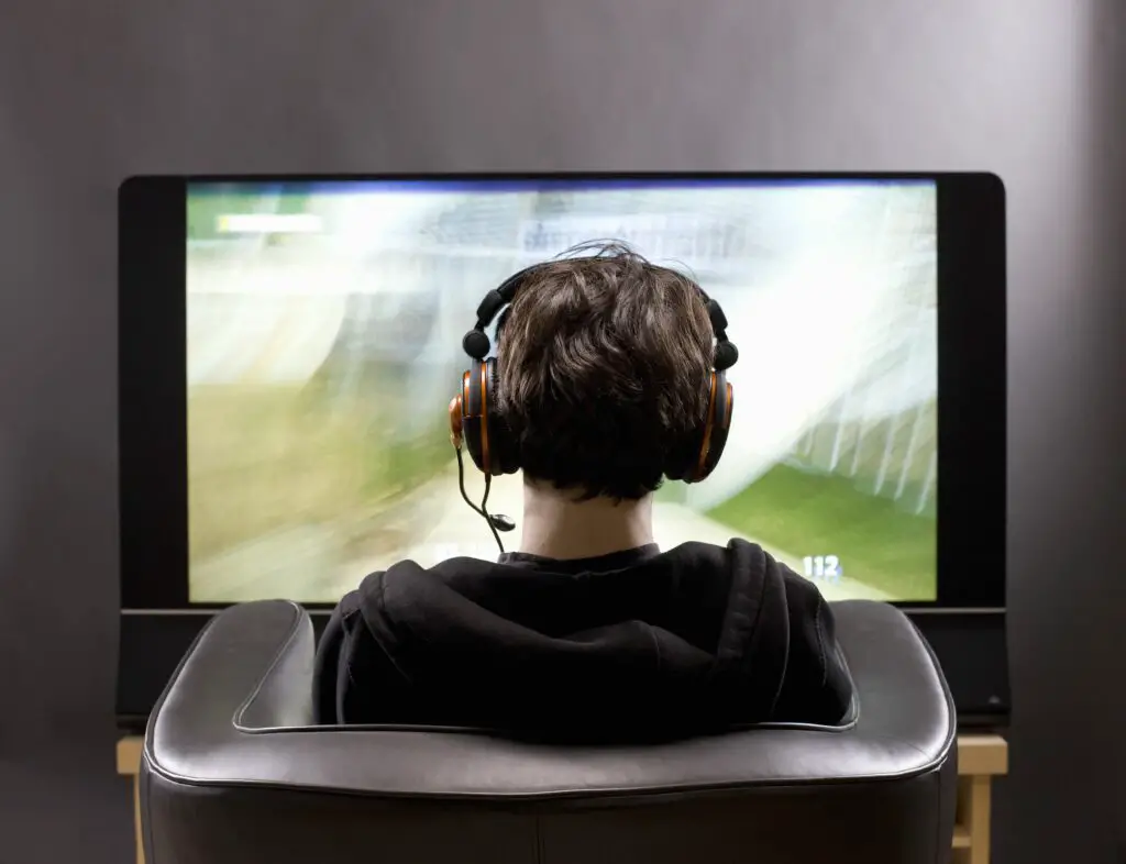 teenage boy sits in front of tv playing video game 106748964 5bde23d34cedfd00263895c0