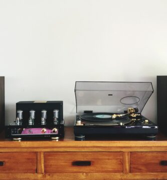 turntable amidst speakers on table by white wall 969624404 5b85ea5c4cedfd0025caf724 5c62e5ddc9e77c0001566d53