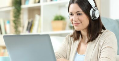 woman with headphones and laptop at home 1280611332 e84e8ba7fbea449b82ced11c31cf7160