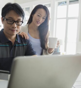 father and daughter with credit card at laptop 547017497 59b080f5d088c00013a7df6d