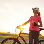 Woman with bicycle on road what to know about insurance coverage 58b61b293df78cdcd84de9e8